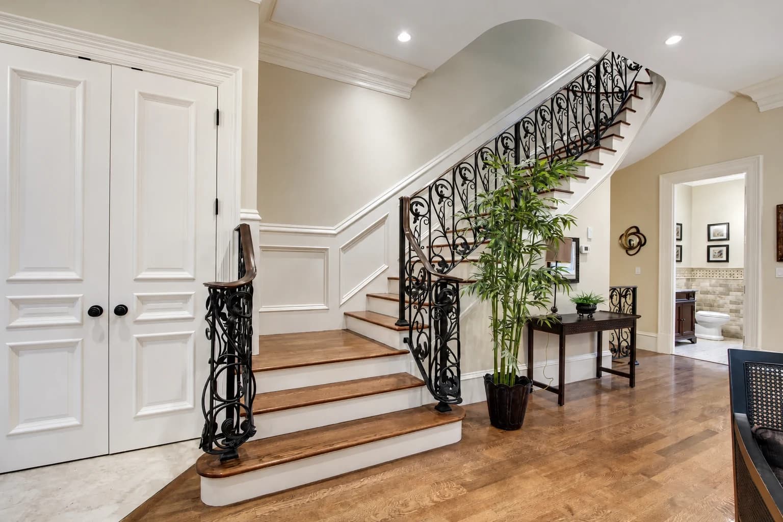 Curved stair with crafted iron balustrade