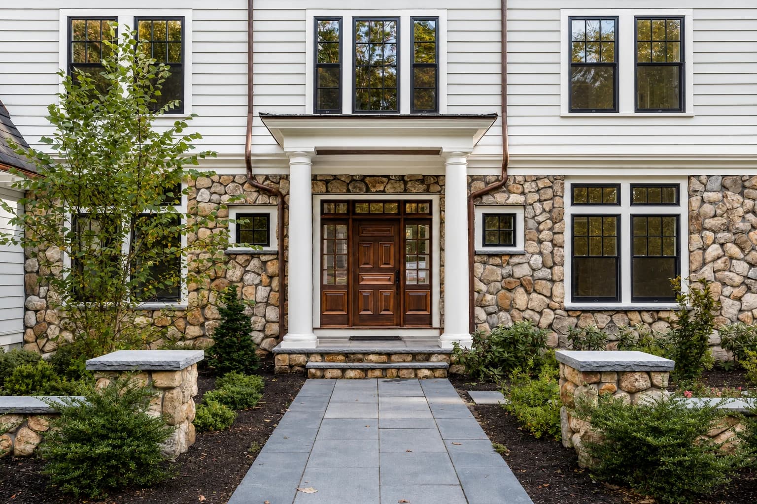 Stone and clapboard custom home entry